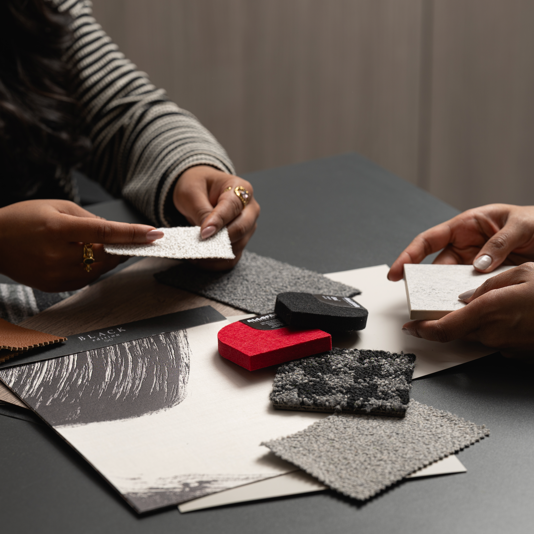 Interior designer reviewing material samples and textures for commercial workspace design